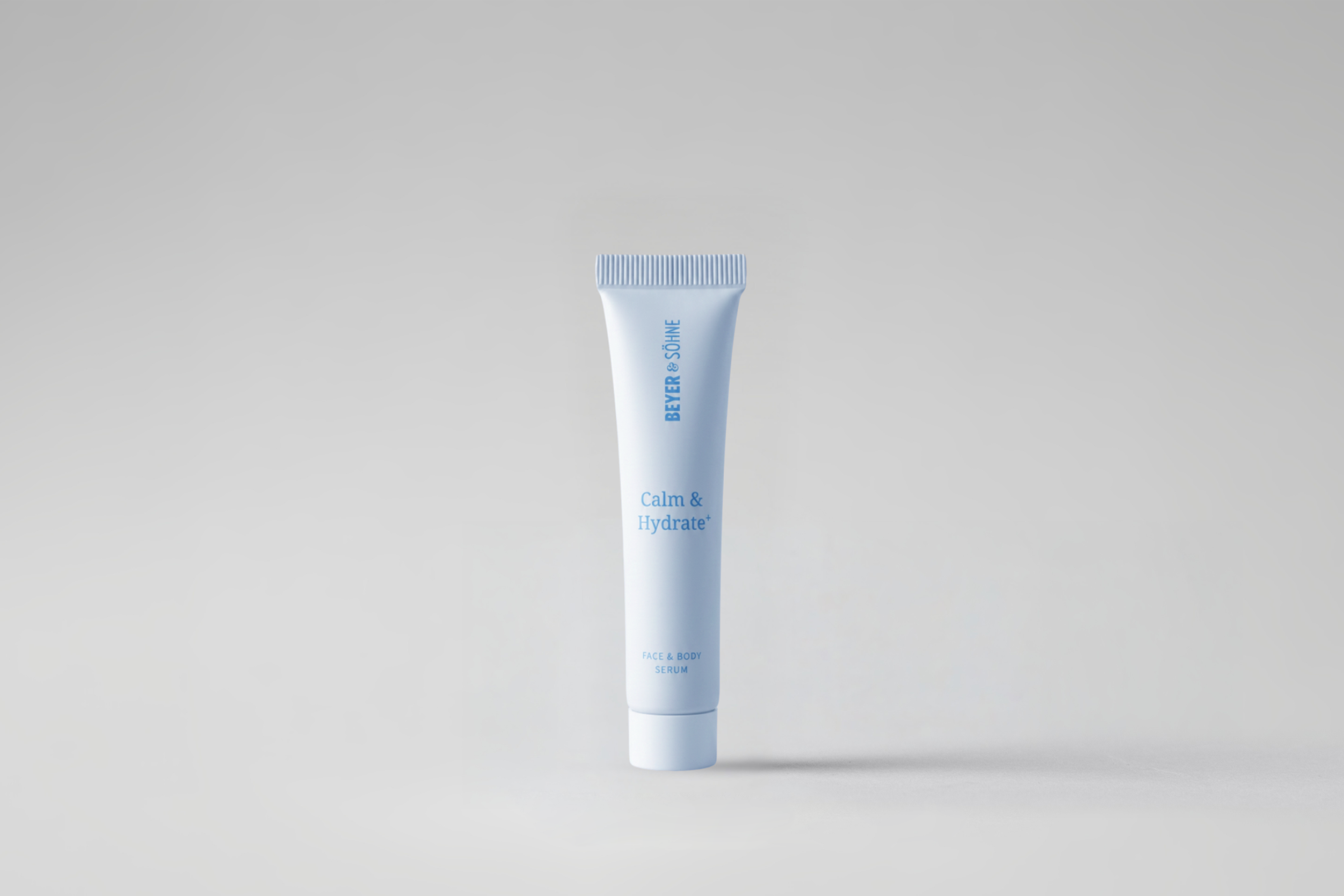 Calm & Hydrate+ in hellblauer Tube vor neutral grauem Hintergrund. Die reduzierte Darstellung unterstreicht den beruhigenden und feuchtigkeitsspendenden Charakter des Produkts.